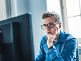Man looking at website on desktop computer